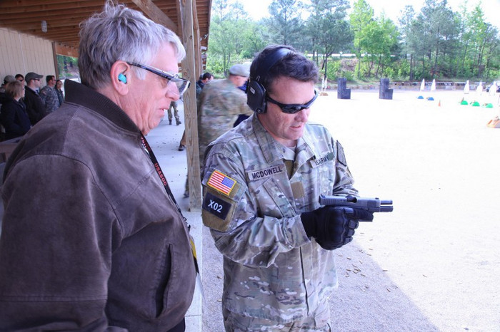 An Army Special Forces soldier shows a Glock to a civilian during a capabilities demonstration in 2012