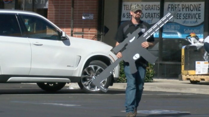 Some scared by cardboard rifle used to advertise gun shop