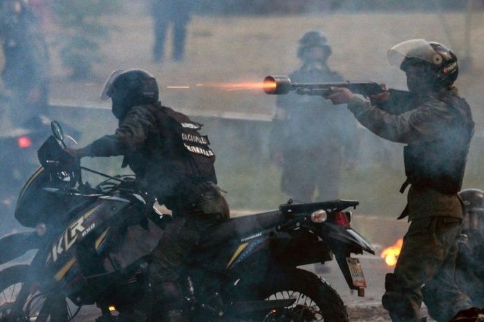 Бійці Боліваріанської національної гвардії стріляють гумовими кулями в демонстрантів, які блокують проспект під час протесту проти президента Венесуели Ніколаса Мадуро в Каракасі 6 липня 2017 року.